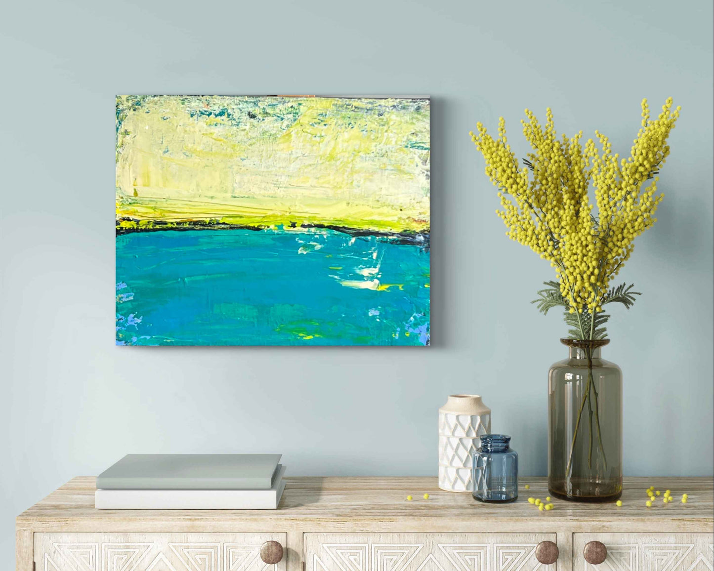 Yellow and teal artwork with white accents and layered palette‑knife texture.