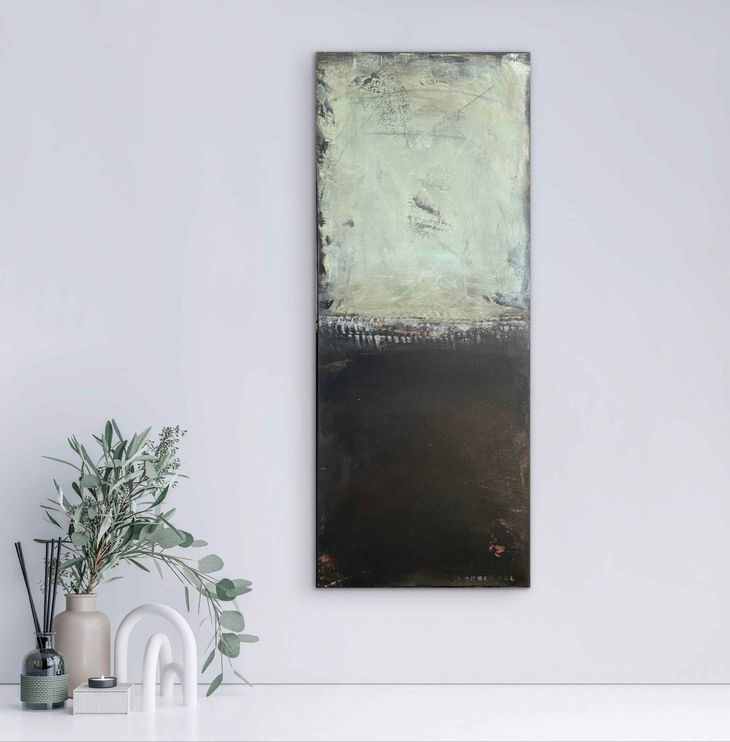 Interior mockup showing the artwork Far Behind displayed on a wall, highlighting its textured light upper field and deep black lower section.