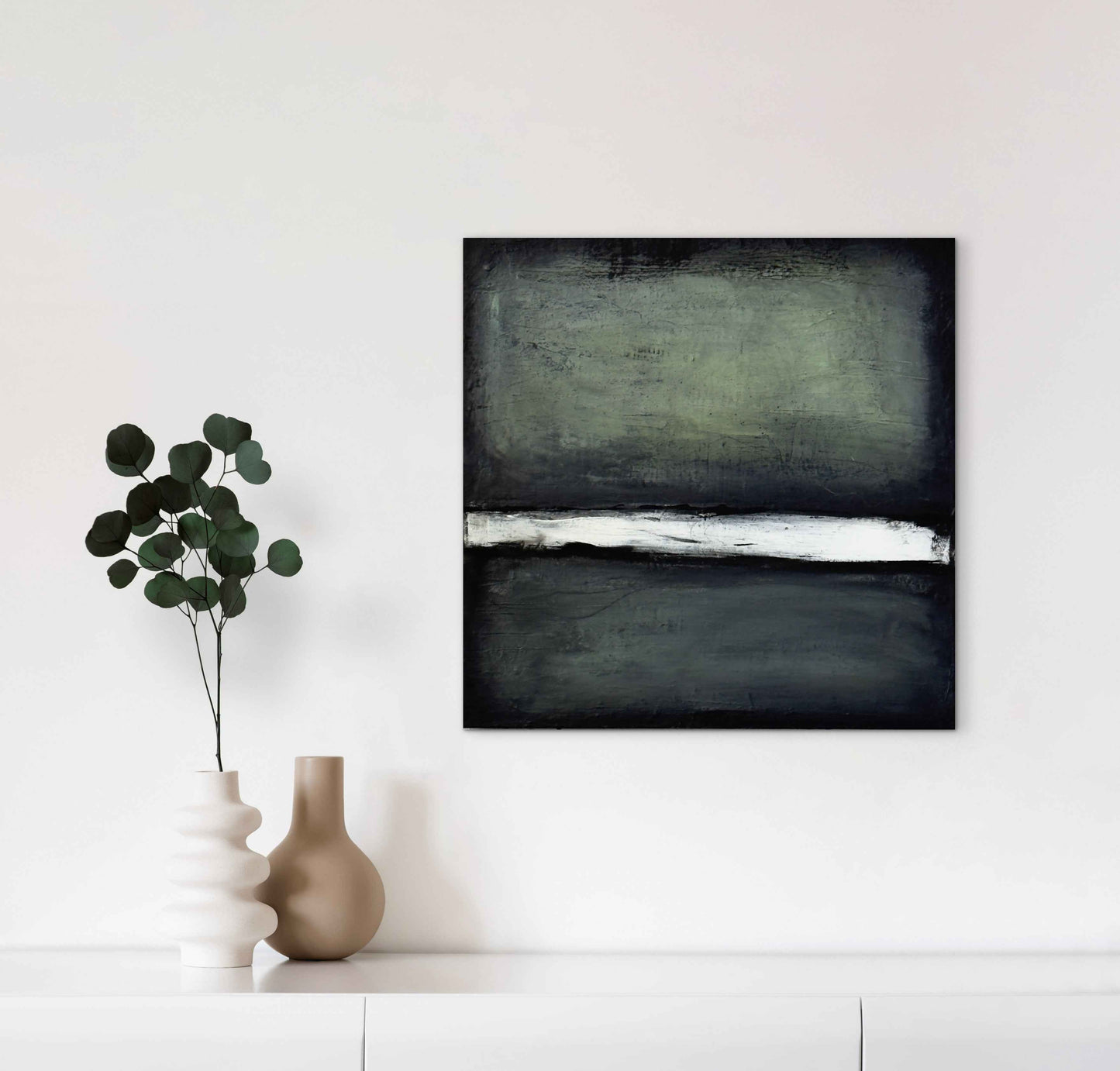 Interior mockup showing the artwork Is This Real? on a wall, highlighting its dark palette and bright central band.