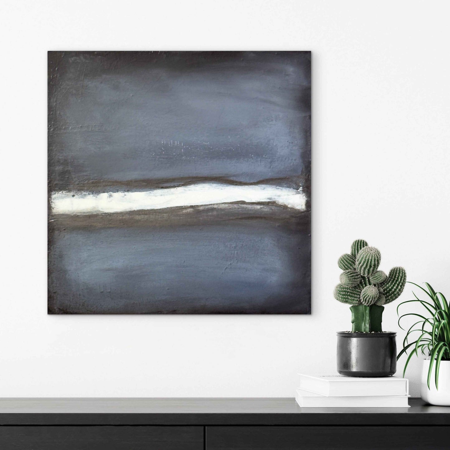 Interior mockup showing the artwork Perception on a wall, highlighting its dark gray palette and bright central band.