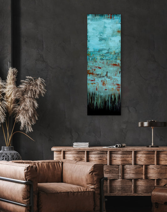 Fading Recollections, 12x36" vertical abstract painting by Michelle Ramos displayed in a modern dark interior above a brown leather sofa. Moody turquoise and rust artwork with atmospheric texture.