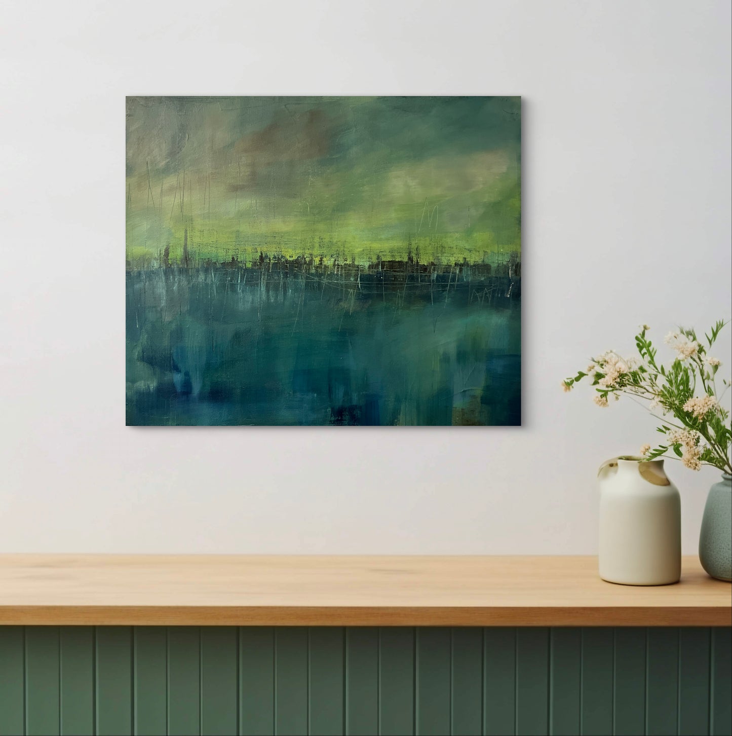 Abstract artwork titled Black Magic Bliss, showing teal and yellow tones with dark skyline band in a modern interior.