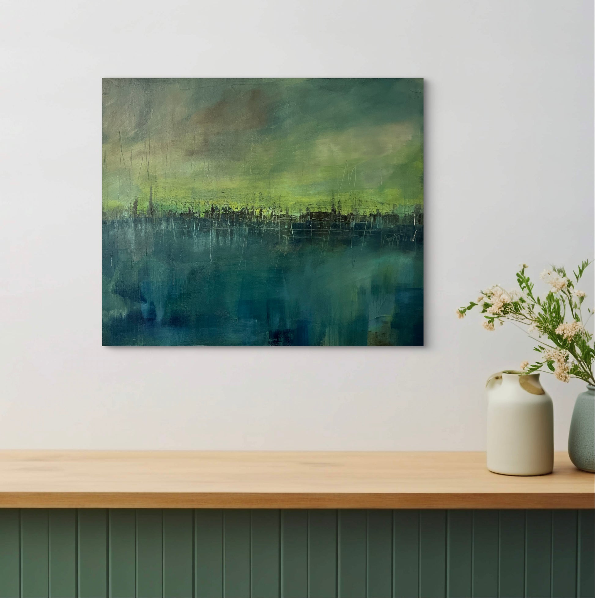Abstract artwork titled Black Magic Bliss, showing teal and yellow tones with dark skyline band in a modern interior.