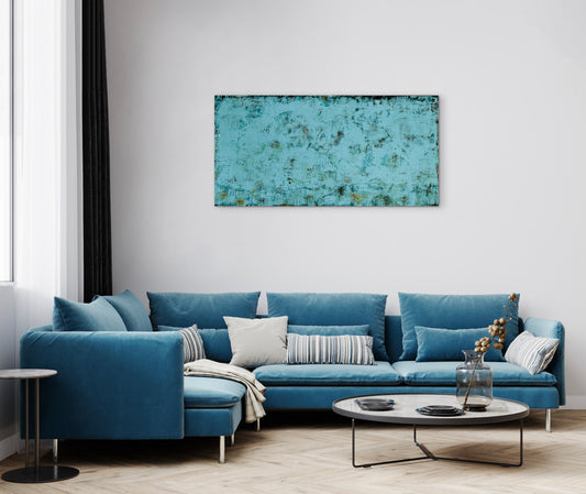 Truth Or Consequences, 24x48" abstract painting by Michelle Ramos displayed in a modern living room above a blue sectional sofa. Moody turquoise and rust artwork with atmospheric depth.