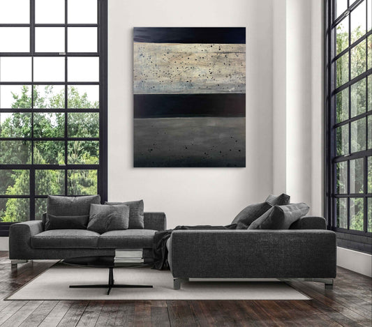 Abstract artwork titled The Space Between, showing black, gray, and beige bands with expressive texture in a modern interior.