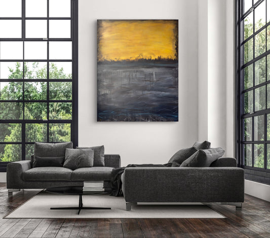 A room mockup showing a large horizontal abstract painting with a bright yellow top section and dark textured lower section hanging above modern furniture.